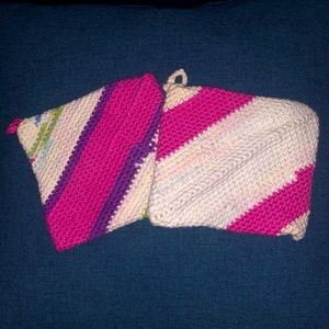 One pair of pink, purple, green, white, and blue striped potholders